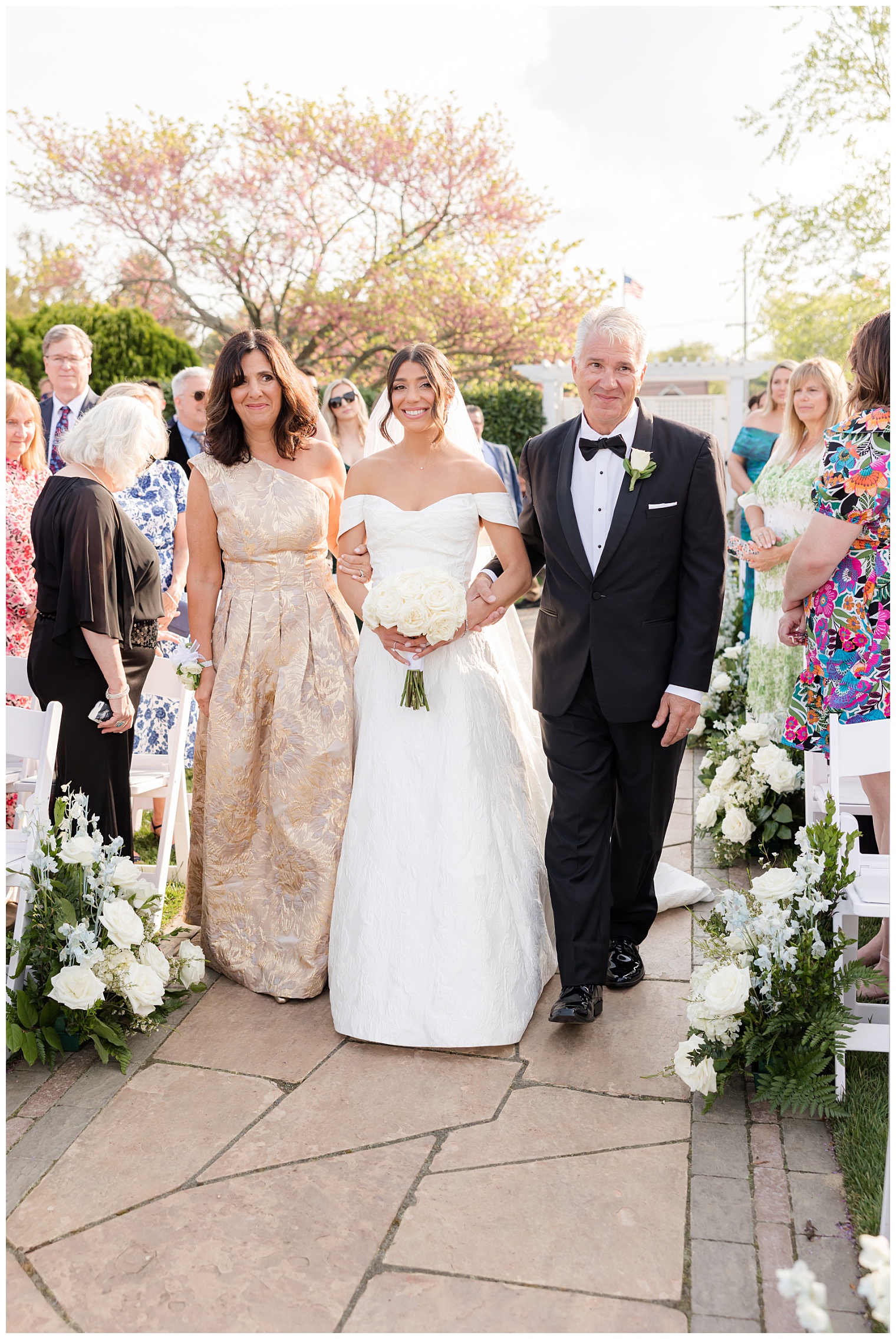 bride walking down the aisle with her parents