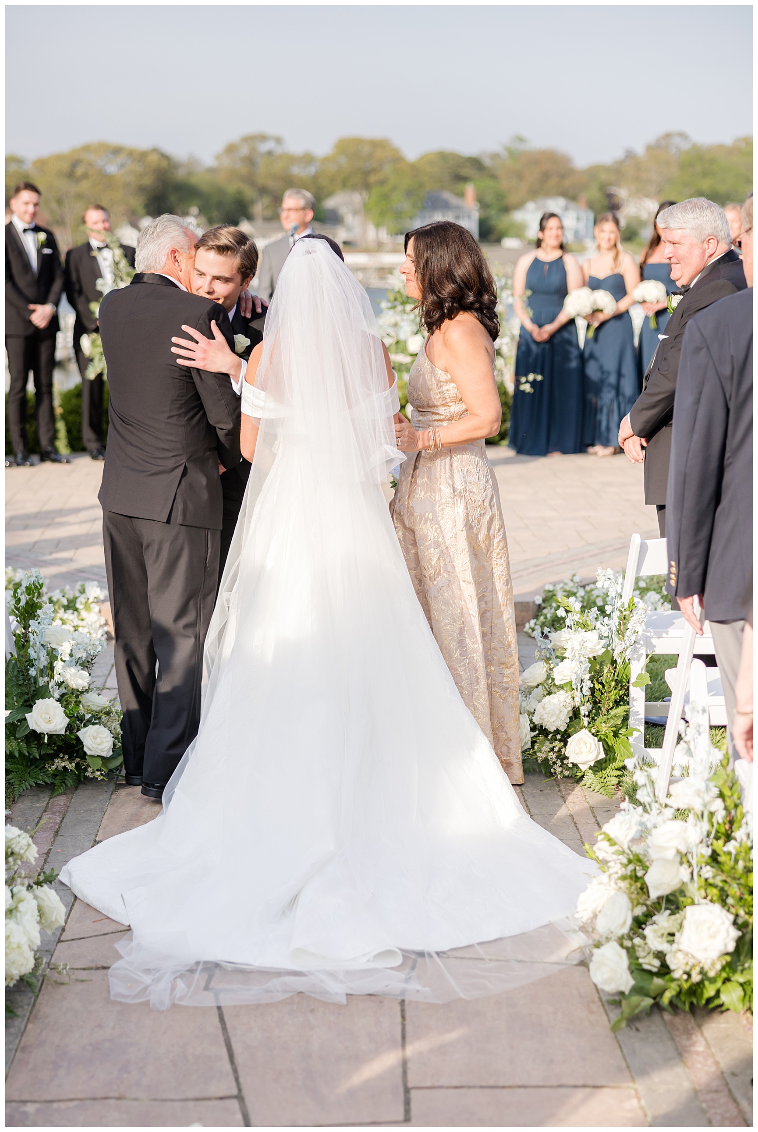 bride walking down the aisle with her parents