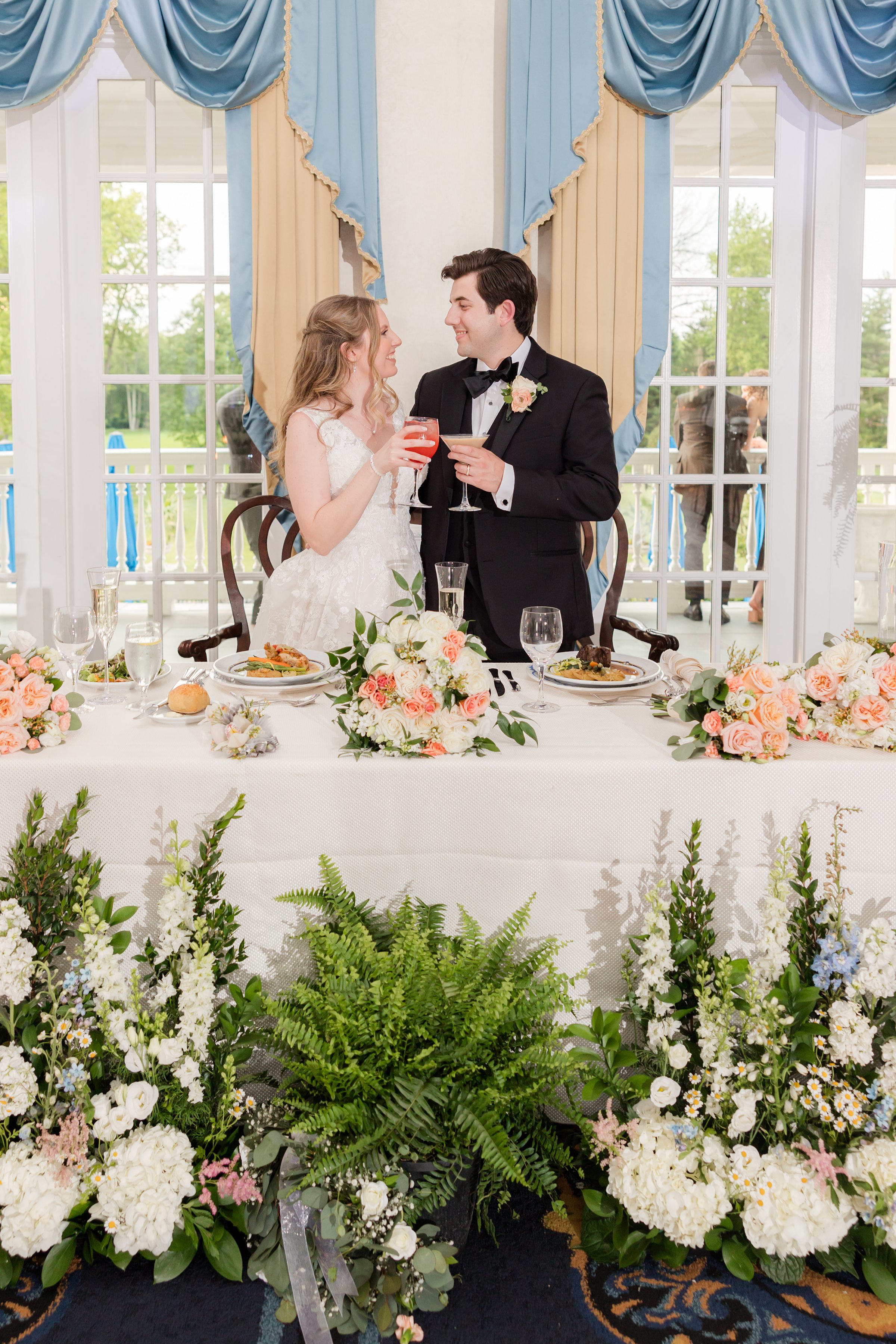 Bride and groom toasting at their sweetheart table