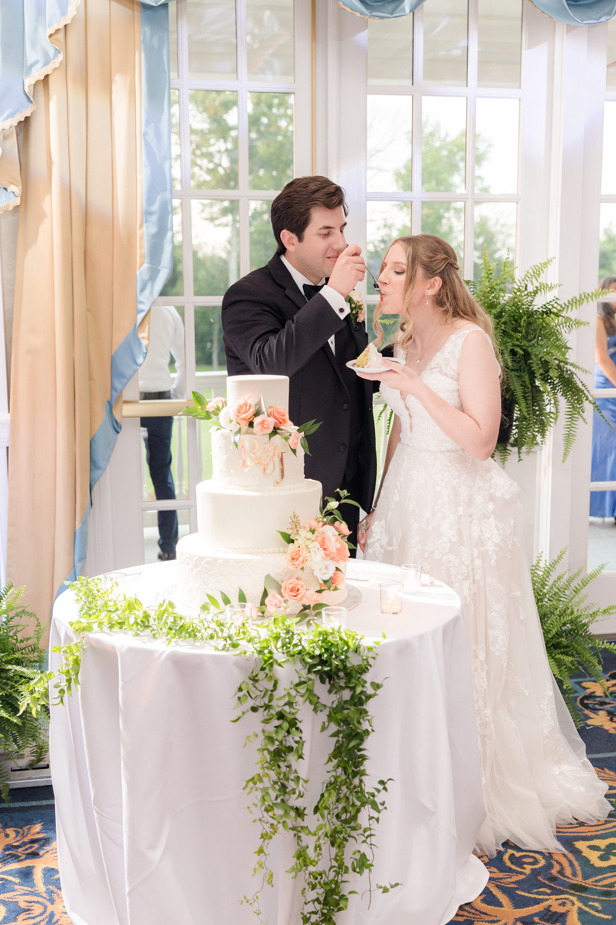 Bride and groom cake cutting and feeding