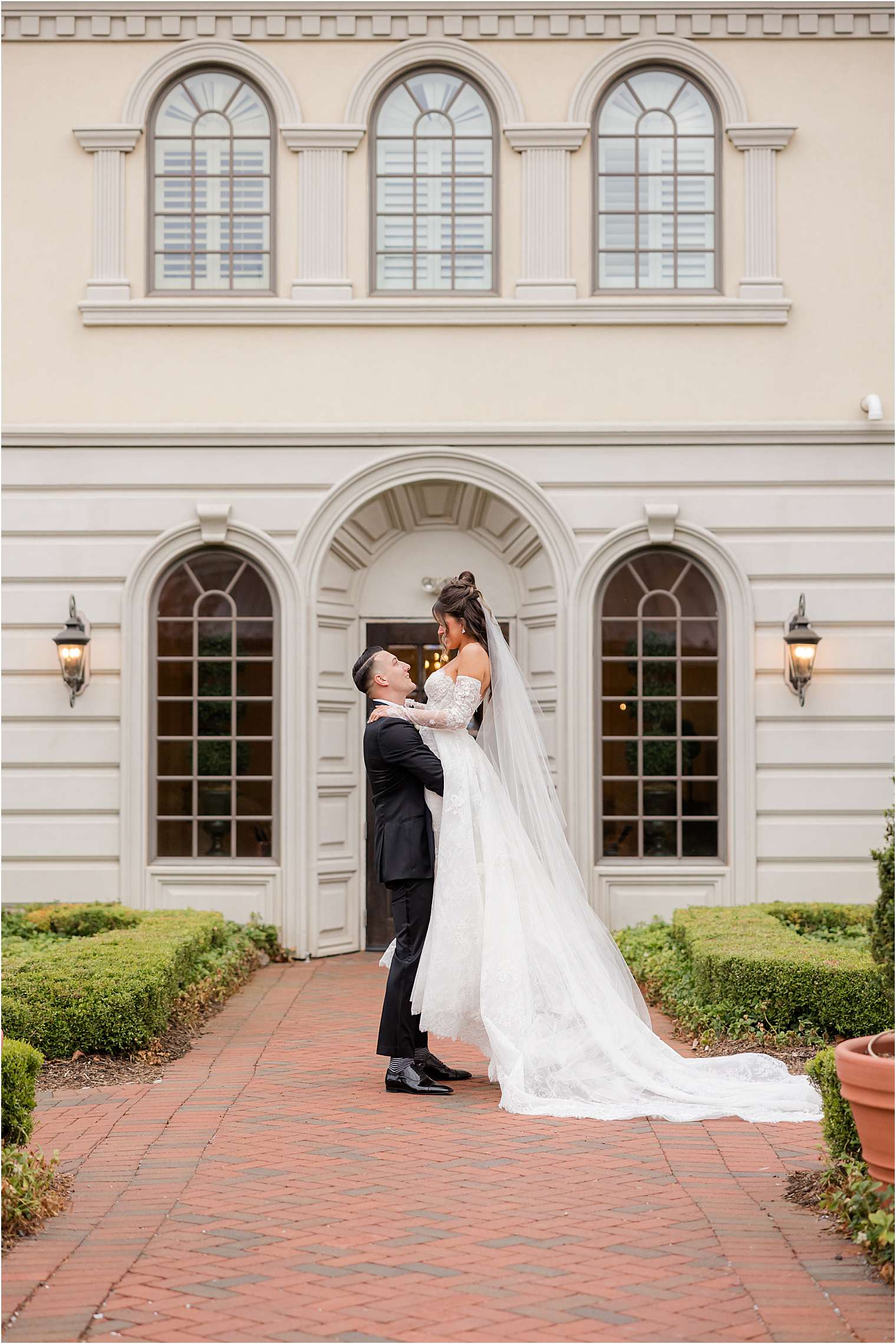 groom lifting bride during photo session at Ashford Estate in Allentown NJ