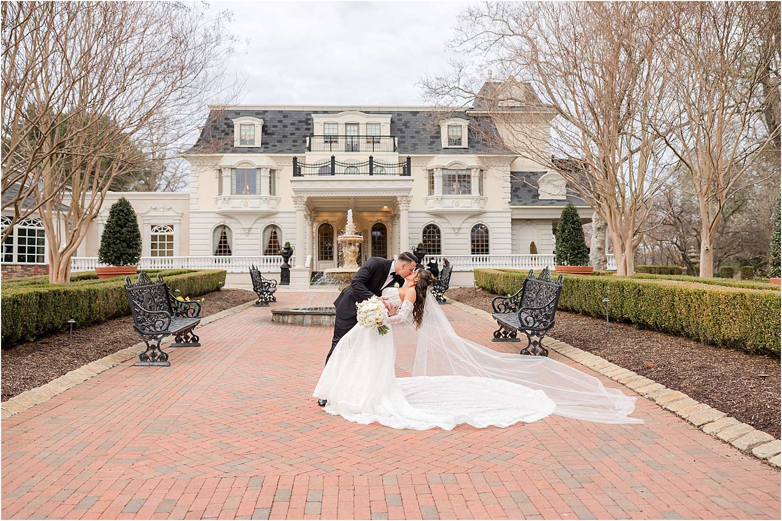 bride and groom kiss in front of Ashford Estate in Allentown NJ