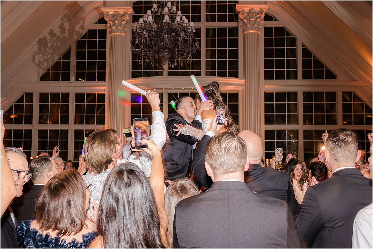 bride and groom kissing in between the crowded dance floor at Ashford Estate in Allentown NJ